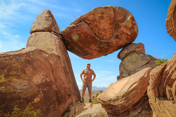 Chet standing under Balanced Rock