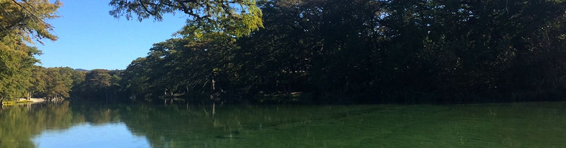 Lake area with tree lined shore.
