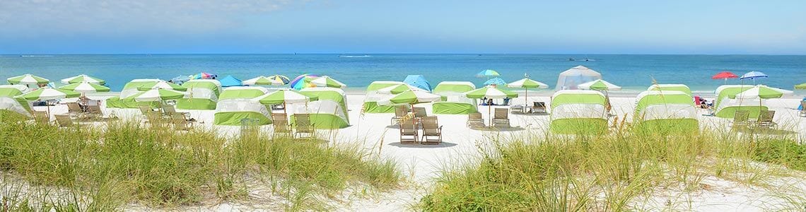 Beautiful white sand beach with umbrellas in FL