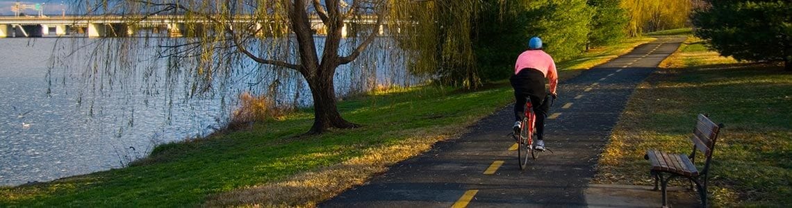 Cyclist on  bike trail next to the Potomac River in DC