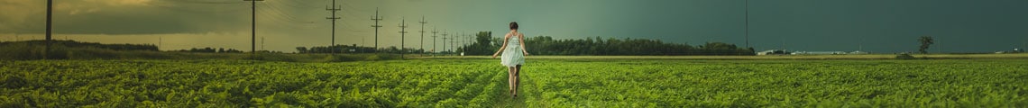 Girl walking through farmland