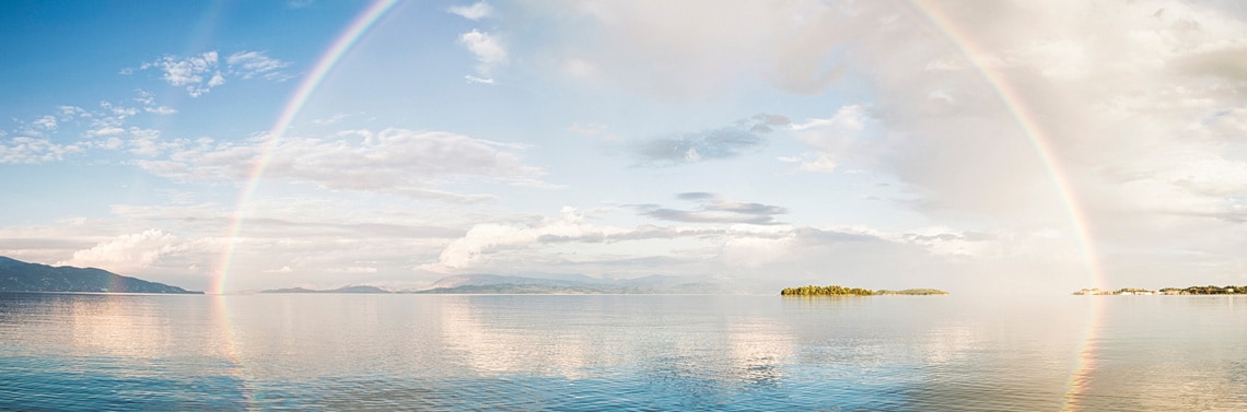 A rainbow extended over the water.